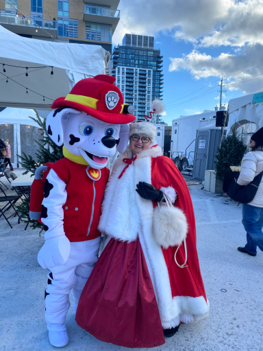 Marshall posing for a photo with Mrs. Santa Claus character.