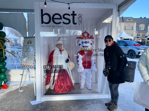 Marshall character and Mrs. Clasu character inside of an adult size "memory box" posing with an adult.