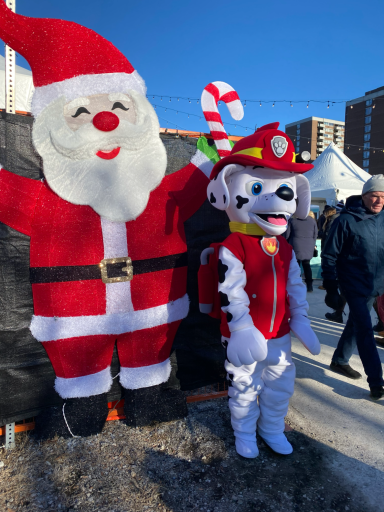 Marshall character in front of a Santa Claus decorative figure.